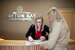 Parkdean guest experience advisor sat at a reception desk helping a guest.